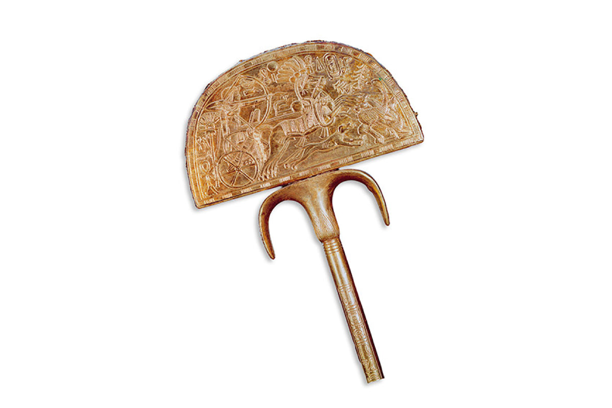 Ancient carved hand fan with a long handle