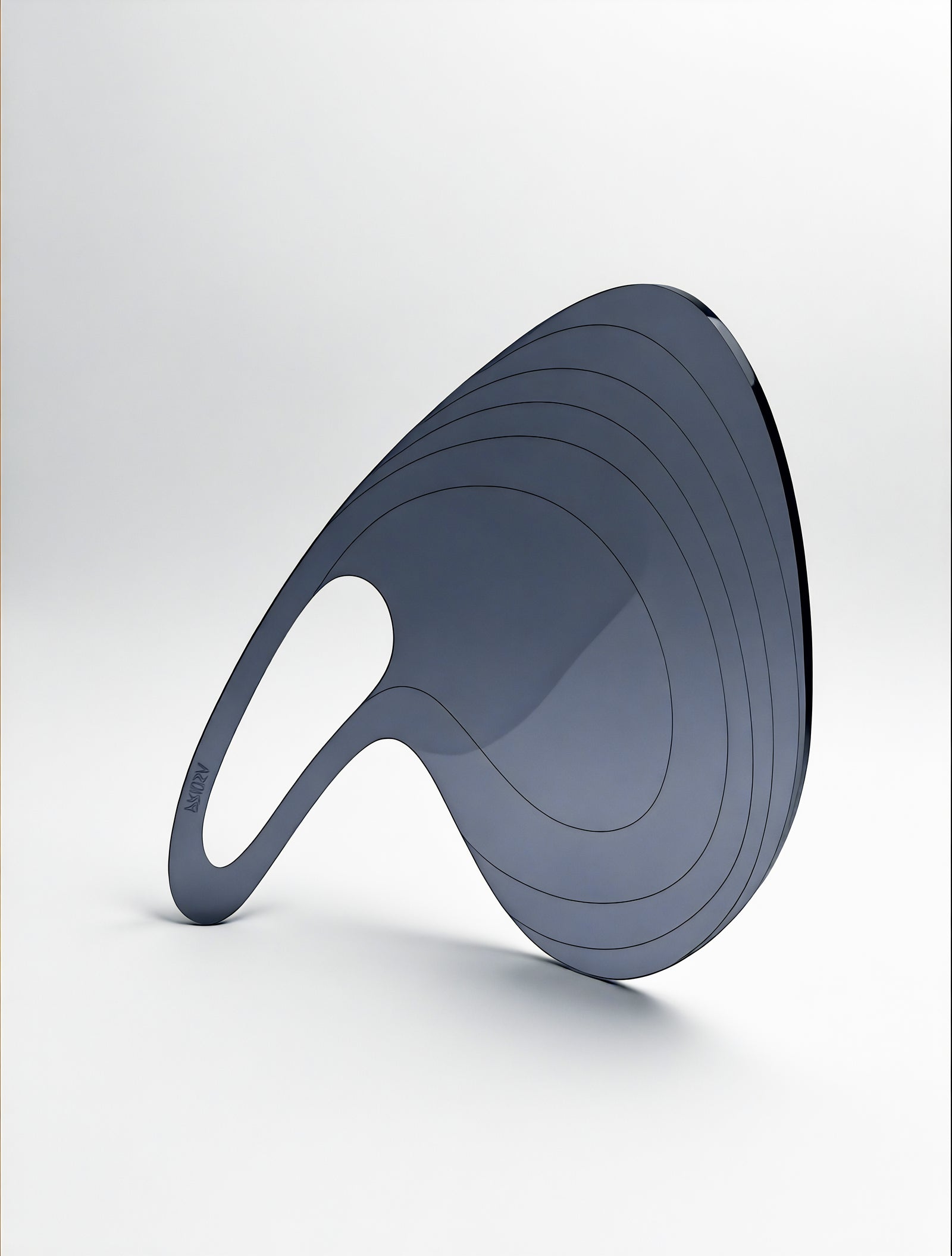 A woman's hand with black manicured nails elegantly holds the PRIOSA Prima translucent acrylic accessory, fingers spread through the oval grip opening, against a black studio background
